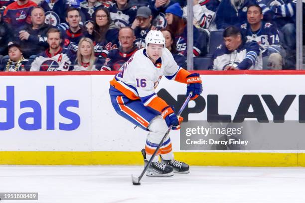 Julien Gauthier of the New York Islanders plays the puck down the ice during third period action against the Winnipeg Jets at the Canada Life Centre...