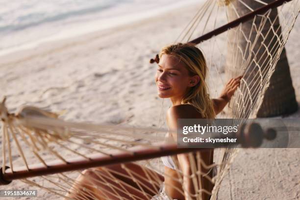 happy woman enjoying in hammock on the beach. - meeru island stock pictures, royalty-free photos & images