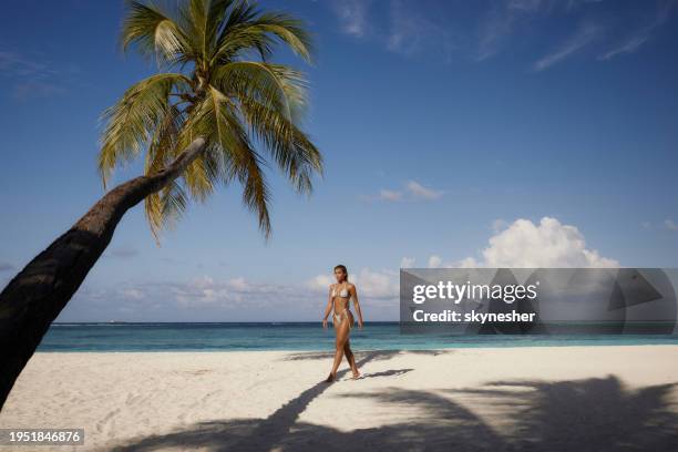 young woman taking a summer walk on the beach. - meeru island stock pictures, royalty-free photos & images