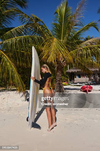 young woman with surfboard during summer day on the beach. - meeru island stockfoto's en -beelden