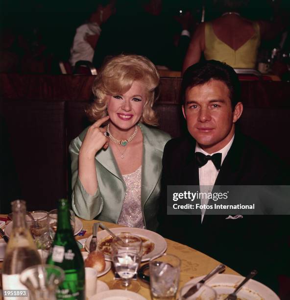 American actor Connie Stevens and her husband, actor James Stacy sit at a table during the Academy Award ceremonies, Santa Monica, California, April...