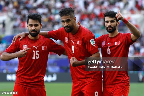 Bahrain's forward Abdulla Yusuf celebrates with teammates after scoring his team's first goal during the Qatar 2023 AFC Asian Cup Group E football...