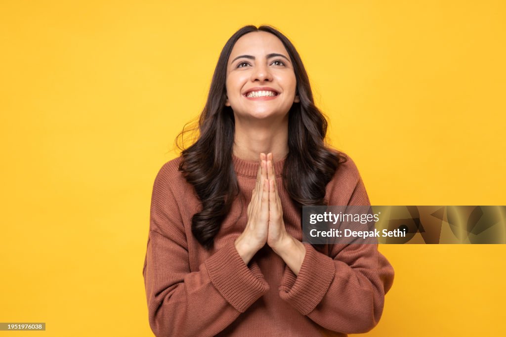Photo of young women in winter wear standing on yellow background stock photo