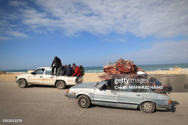 Palestinian families fleeing Khan Yunis on the coastal road leading to Rafah further south drive along the sea with their belongings on their cars on...