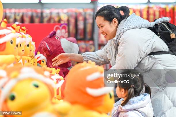 Woman selects dragon toys with her daughter at a shopping mall on January 21, 2024 in Nanchang, Jiangxi Province of China. As the Chinese New Year,...