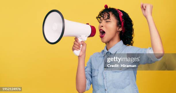 megaphone, speech and woman screaming with power fist in studio for announcement on yellow background. protest, noise and female speaker with warning message of change, transformation and freedom - advertisement stock pictures, royalty-free photos & images