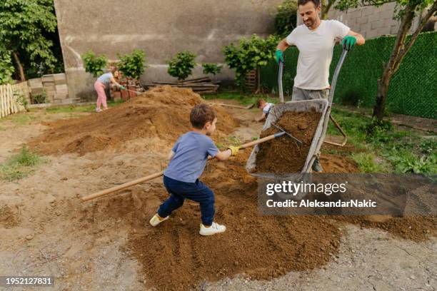 working on a landscape in our yard - kruiwagen stockfoto's en -beelden