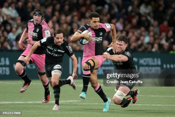 Ben Thomas of Cardiff Rugby between Clovis le Bail and Will Rowlands of Racing 92 during the Investec Champions Cup match between Racing 92 and...