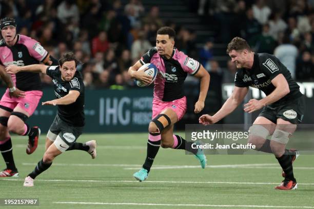 Ben Thomas of Cardiff Rugby between Clovis le Bail and Will Rowlands of Racing 92 during the Investec Champions Cup match between Racing 92 and...