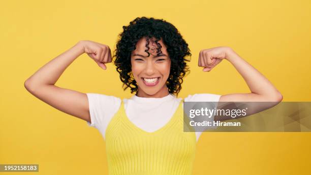 portrait, happy and woman flex muscle in studio isolated on a yellow background mockup space. smile, strong girl and bicep arm for power, empowerment of confident young model and energy for feminism - muscular arm stock pictures, royalty-free photos & images