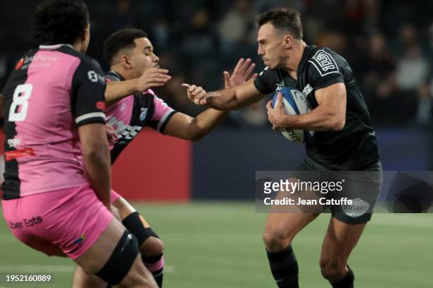 Juan Imhoff of Racing 92, left Ben Thomas of Cardiff Rugby in action during the Investec Champions Cup match between Racing 92 and Cardiff Rugby at...