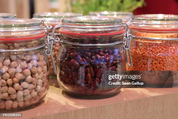 Legumes, including chickpeas, kidney beans and lentils, stand in glass jars on display at the Green Week agricultural trade fair on its opening day...