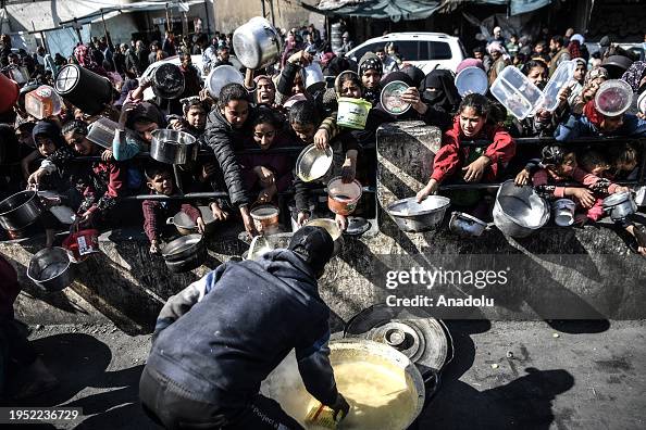 Palestinians in Gaza queue for hours for food