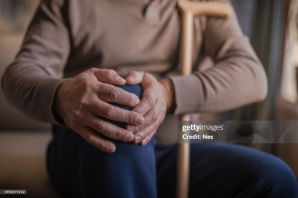 Lonely man holding his knee