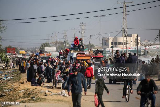 Palestinian citizens displaced from the city of Khan Yunis due to Israeli raids travel to the city of Rafah, south of the Gaza Strip on January 22,...