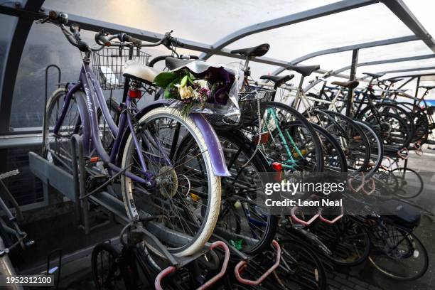Decaying bunch of flowers is seen in the basket of an abandoned bicycle, in a storage area at Euston station on January 22, 2024 in London, United...