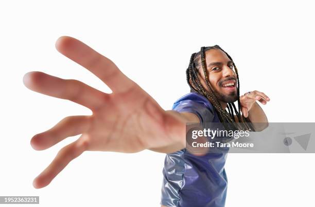 hipster man reaching out to camera - reiken stockfoto's en -beelden