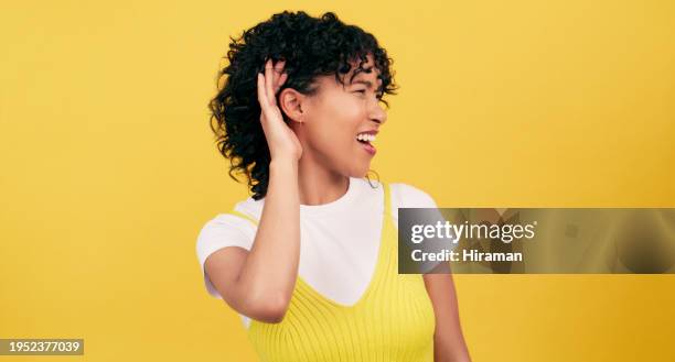 hand, ear and woman in studio with deaf, gesture or speak up sign on yellow background space. volume, secret and curious female model with palm emoji for listening to gossip, information or hearing - hear emoji bildbanksfoton och bilder