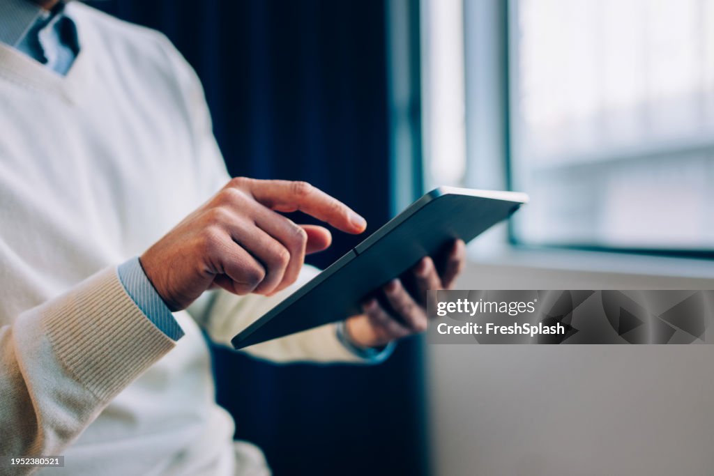 Corporate Focus: Hand of a Businessman Holding His Tablet