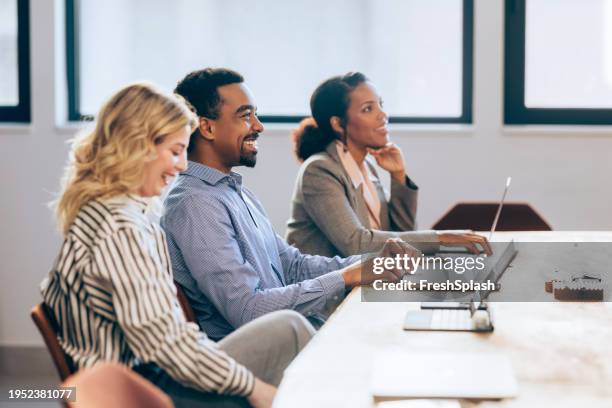 strategic minds at work: smiling business team meeting - type stock pictures, royalty-free photos & images