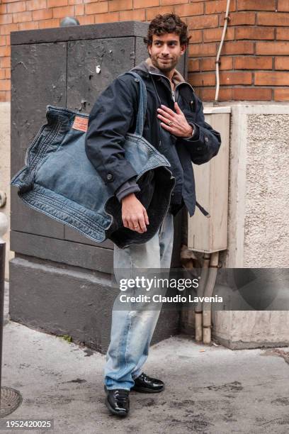 Andrew Georgiades wears dark blue jacket, jeans, big denim bag, outside Wooyoungmi, during the Menswear Fall/Winter 2024/2025 as part of Paris...