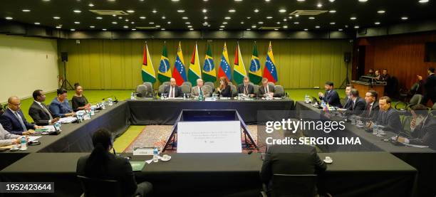 Brazil's Foreign Minister Mauro Vieira , Venezuela's Foreign Minister Yvan Gil and Guyana's Foreign Minister Hugh Todd attend a meeting between...