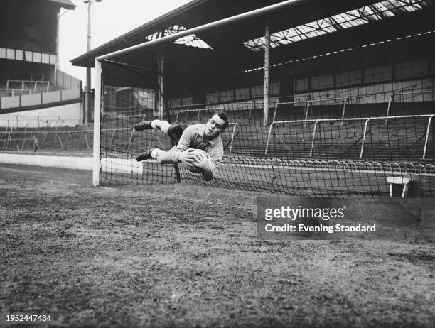 English footballer Alan Hodgkinson , a goalkeeper with Sheffield Wednesday, diving to make a save during training with the England national team at...