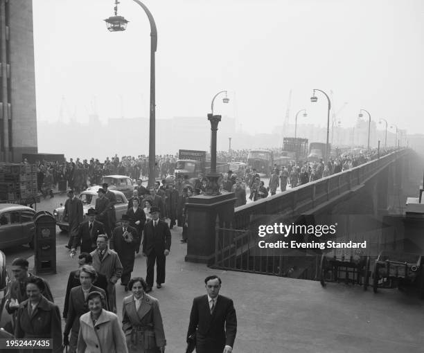 View of commuters crossing London Bridge, April 9th 1957. Following a fire on April 5th, Cannon Street Station was closed completely for three days...