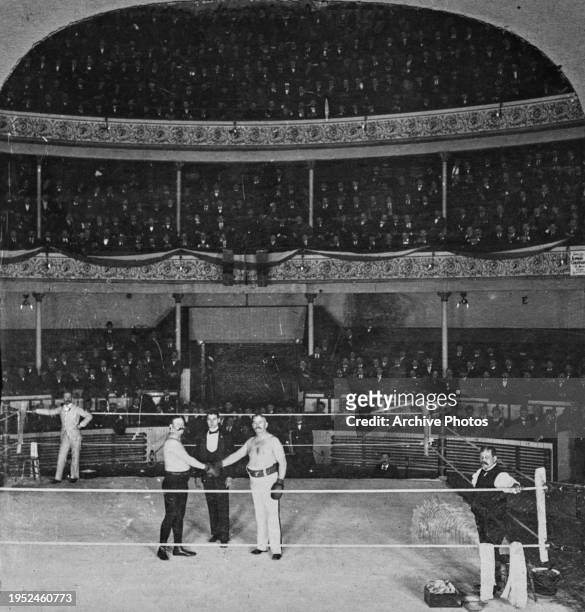 American boxer John L Sullivan touching gloves with Irish-born American boxer Paddy Ryan in the ring ahead of their exhibition bout at the 'Arena' in...