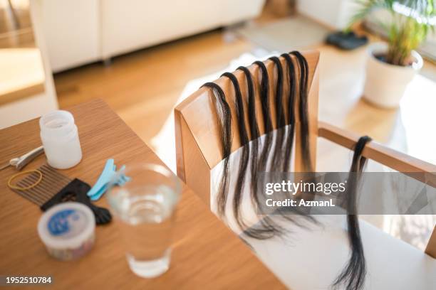 homemade hair braiding setup with hair extensions and accessories - hair extension stock pictures, royalty-free photos & images