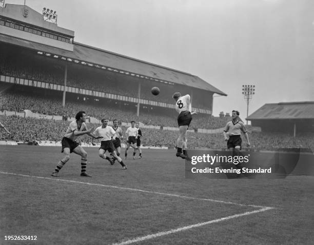 Players including Spurs midfielder Danny Blanchflower and Wolverhampton Wanderers' Bill Slater and Eddie Clamp in action during a match at White Hart...