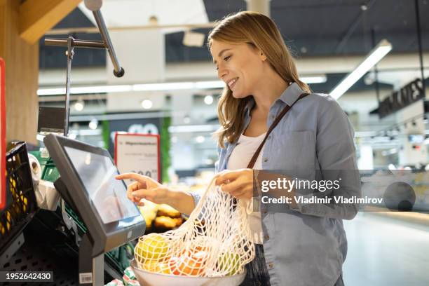 woman using self service checkout - megastore stock pictures, royalty-free photos & images