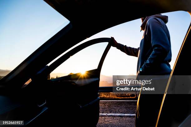 stopping during a road trip to contemplate the sunset over the landscape. - car point of view stock pictures, royalty-free photos & images