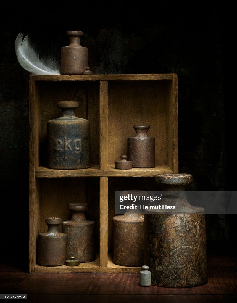 Old iron weights in a wooden box