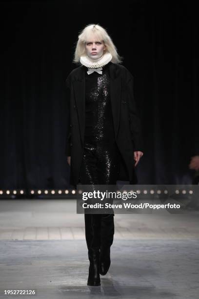 Model walks the runway at the Veronique Branquinho show during Paris Fashion Week Autumn/Winter 2016/17, she wears black sequinned slim fit trousers...