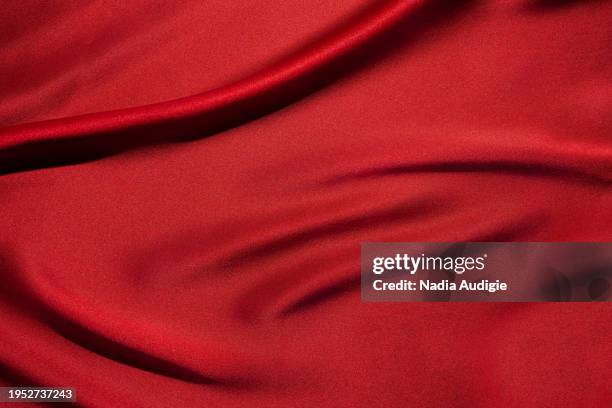 draped red silk background - backgrounds stock-fotos und bilder