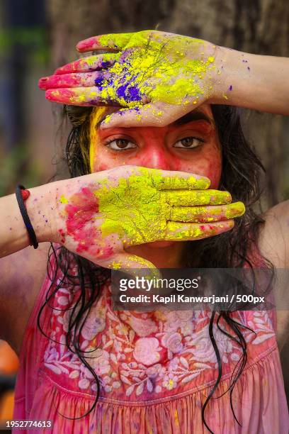 portrait of woman holding powder paint - holi portraits stock pictures, royalty-free photos & images