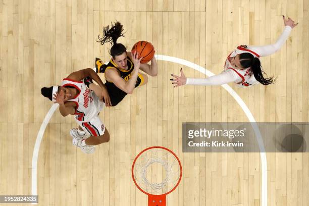 Caitlin Clark of the Iowa Hawkeyes shoots the ball while being defended by Taylor Thierry of the Ohio State Buckeyes during the game at Value City...