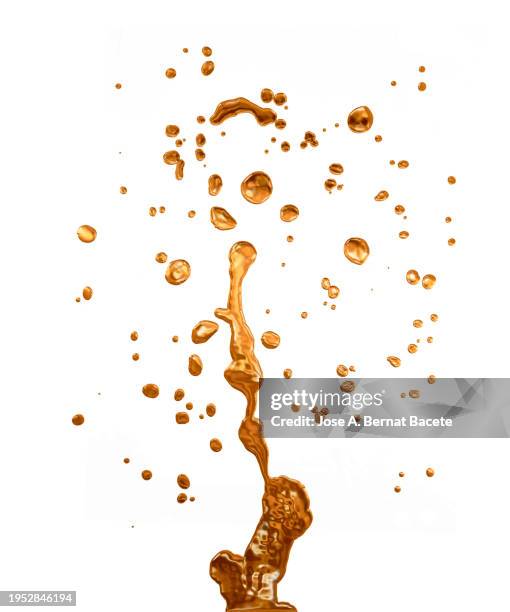 jet of golden liquid drops in upward motion on a white canvas. - lubricación fotografías e imágenes de stock