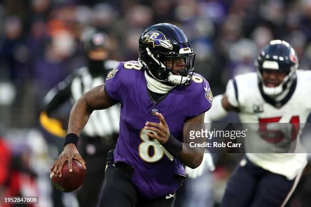 Quarterback Lamar Jackson of the Baltimore Ravens looks to pass against the Houston Texans during the AFC Divisional Playoff game at M&T Bank Stadium...