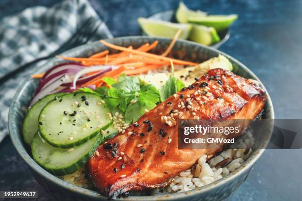 spicy salmon bowl with rice, carrots, cucumber and avocado - salmon steak stock pictures, royalty-free photos & images