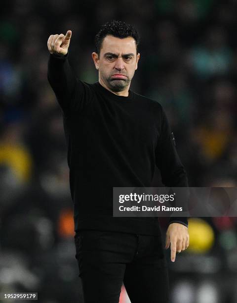 Head Coach Xavi Hernandez of FC Barcelona directs his players during the LaLiga EA Sports match between Real Betis and FC Barcelona at Estadio Benito...