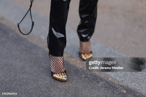 Corina Mihaila Larpin seen wearing YSL black varnished leather / patent straight leg pants, black fishnet socks and Schiaparelli black leather heels...