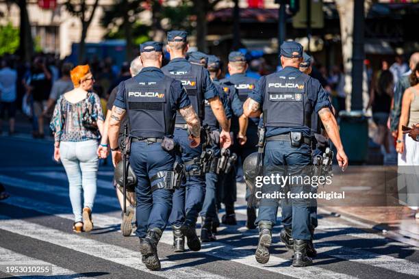 group of policeman walking in valencia, spain - several spanish police stock pictures, royalty-free photos & images