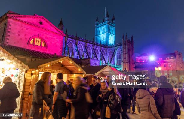 Christmas shoppers browse stalls at the traditional Christmas market that has opened in the centre of the historic city on December 12, 2023 in Bath,...