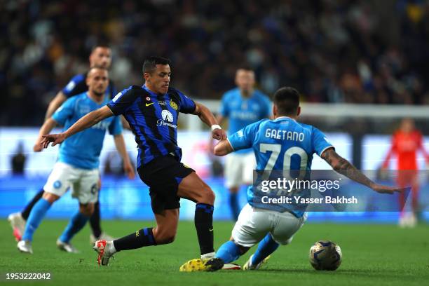 Alexis Sanchez of FC Internazionale challenges for the ball with Gianluca Gaetano of SSC Napoli during the Italian EA Sports FC Supercup Final match...