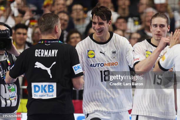 Head coach Alfred Gislason and Julian Koester of Germany celebrate after the Men's EHF Euro 2024 main round match between Germany and Hungary at...