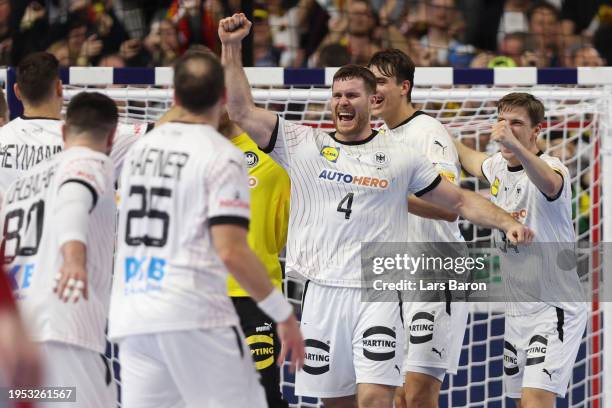 Johannes Golla and teammates of Germany celebrate victory after the Men's EHF Euro 2024 main round match between Germany and Hungary at Lanxess Arena...