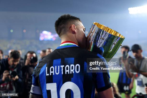 Lautaro Martinez of FC Internazionale kisses the Italian EA Sports FC Supercup Final trophy at full-time following victory in the Italian EA Sports...