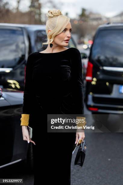 Guest wears black velvet dress outside Schiaparelli during the Haute Couture Spring/Summer 2024 as part of Paris Fashion Week on January 22, 2024 in...